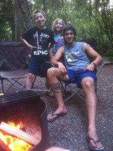Before the summer fire ban sets in, Zach, Beth-Rose and Gabriel enjoy the camp fire.