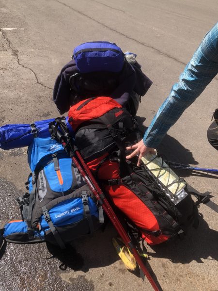 A pile of hiking gear waiting to be loaded