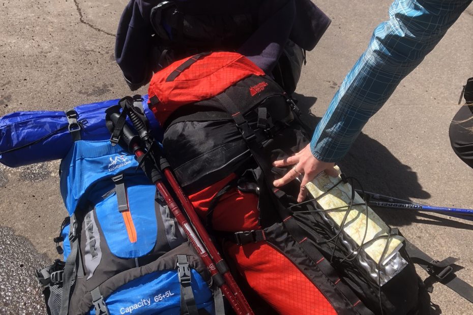 A pile of hiking gear waiting to be loaded