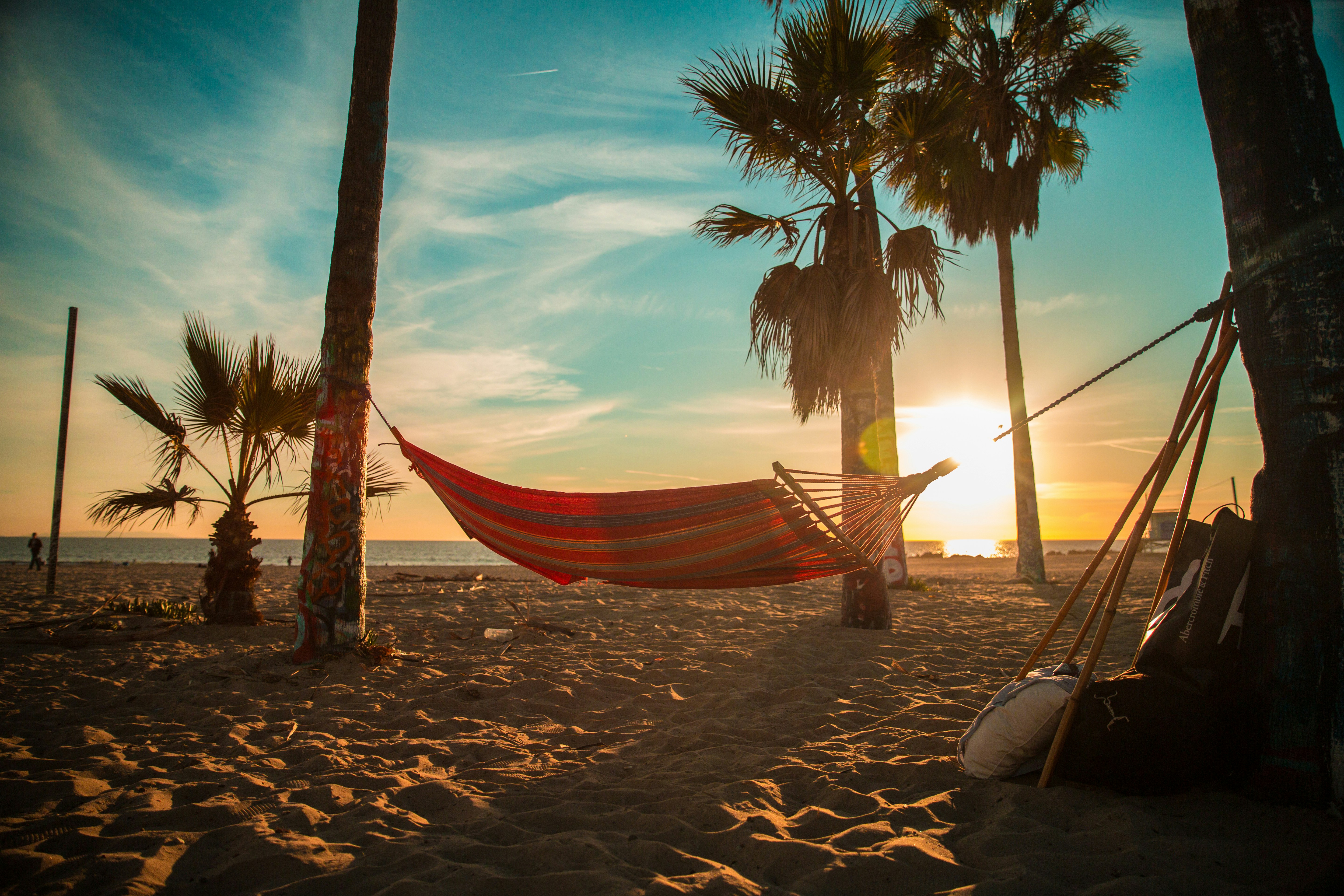 A hammock on the beach at sunset