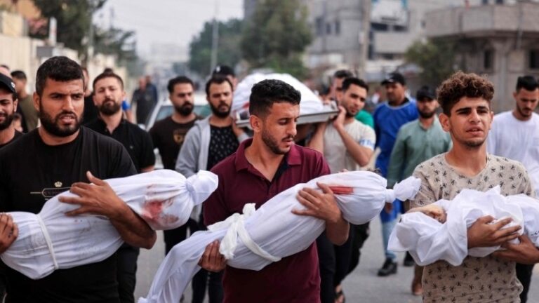Gaza genocide- Palestinian families carrying their dead children wrapped in white cloths