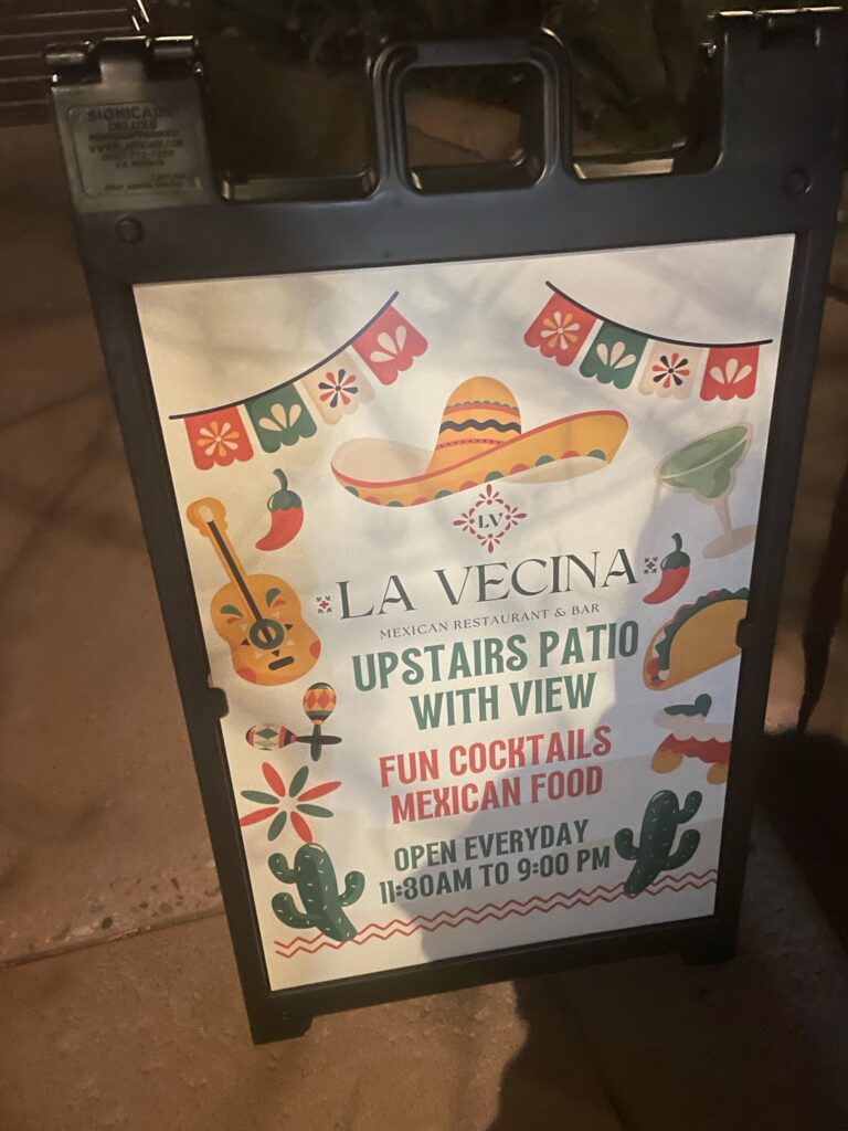 sidewalk sign for La Vecina restaurant in Sedona
